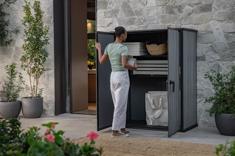 Outdoor Scene, Venetian hi store vertical shed & storage box lifestyle, female opening door for sale in Dublin, best price, budget friendly, extra discount