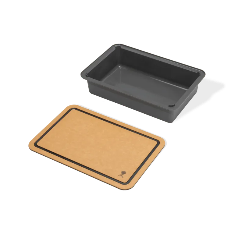 Weber Basin with cutting board for weber gas grills in lifestyle setting on a weber BBQ side shelf. real life cooking skewers.