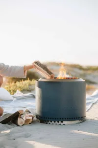 Bonfire solo stove firepit for sale from Outdoor scene. Bonfire outdoors with wood logs.