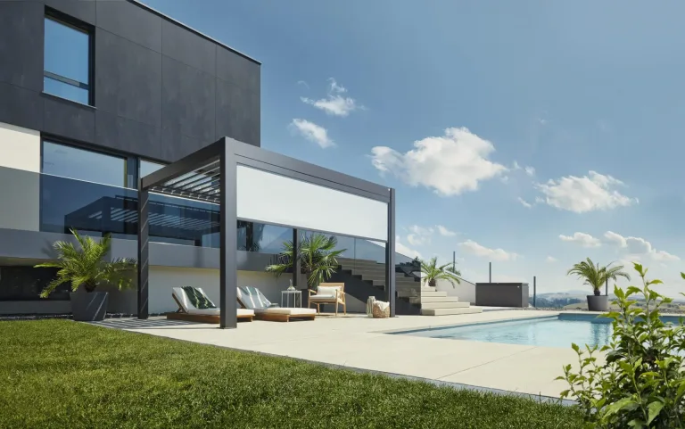 Biohort Pergola in size 3 x 3m for installation and sale in Ireland from Ireland's Premium Garden center The Outdoor Scene. Lifestyle Pergola picture in garden with front blinds