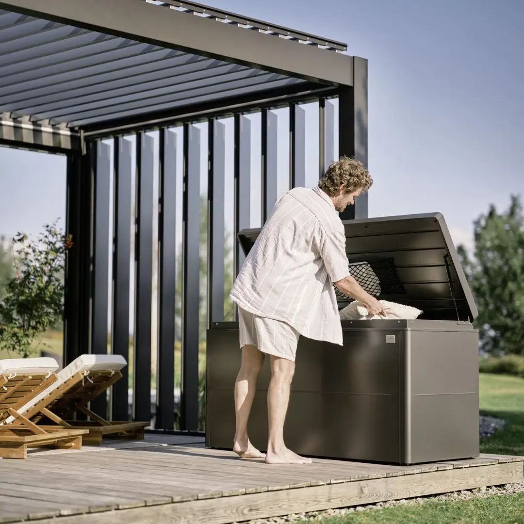 Biohort LoungeBox storing outdoor furniture cushions on a modern patio