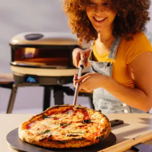 Stainless steel Gozney Utility Turning Peel for serving fresh pizza